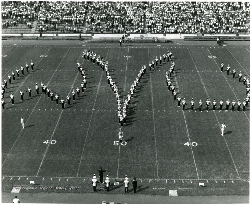 band forming the letters WVU on the football field